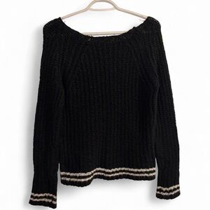 Black and white striped sweater with off-the-shoulder detail